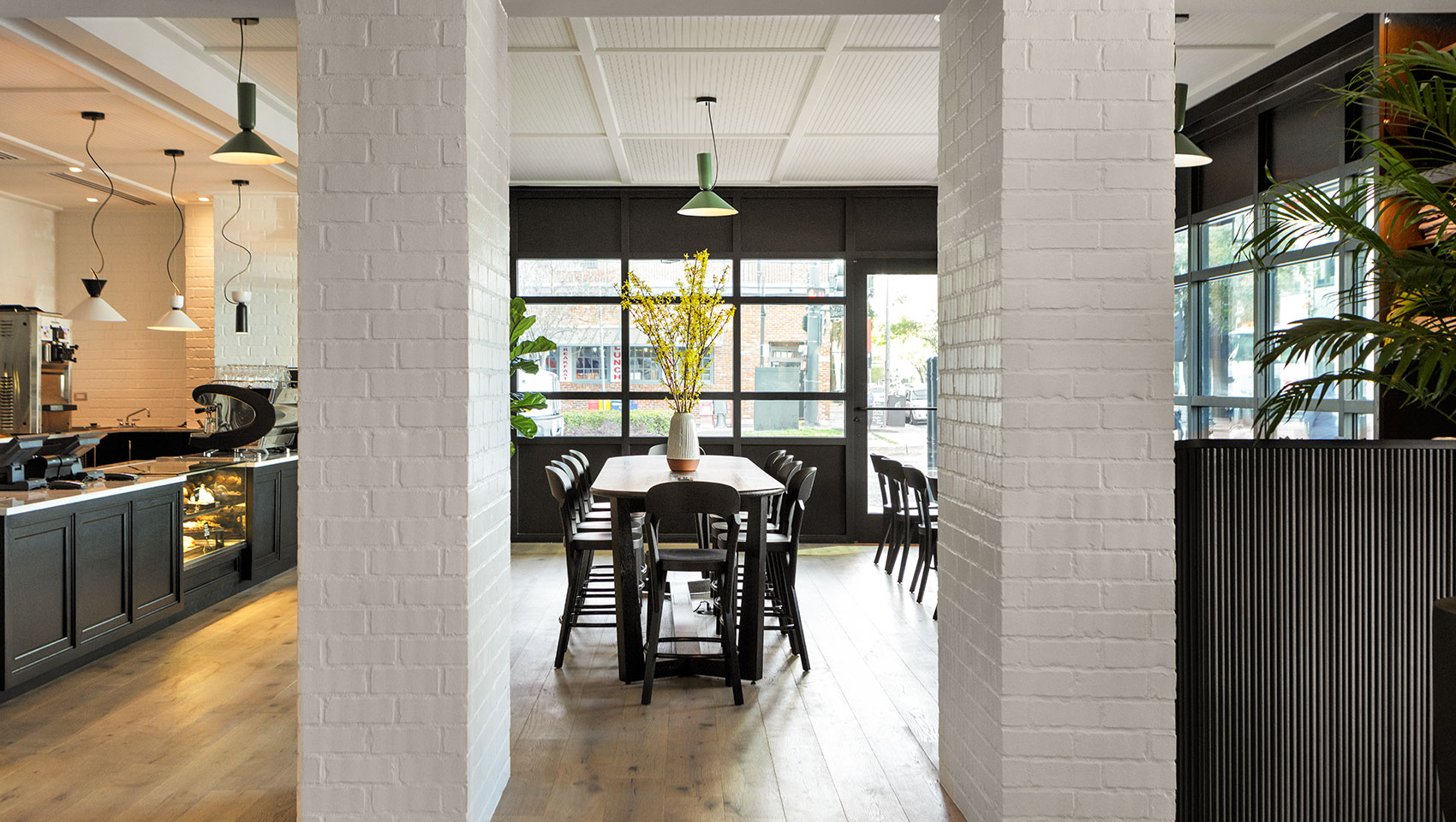 cafe entrance from hotel lobby with white beams and tables