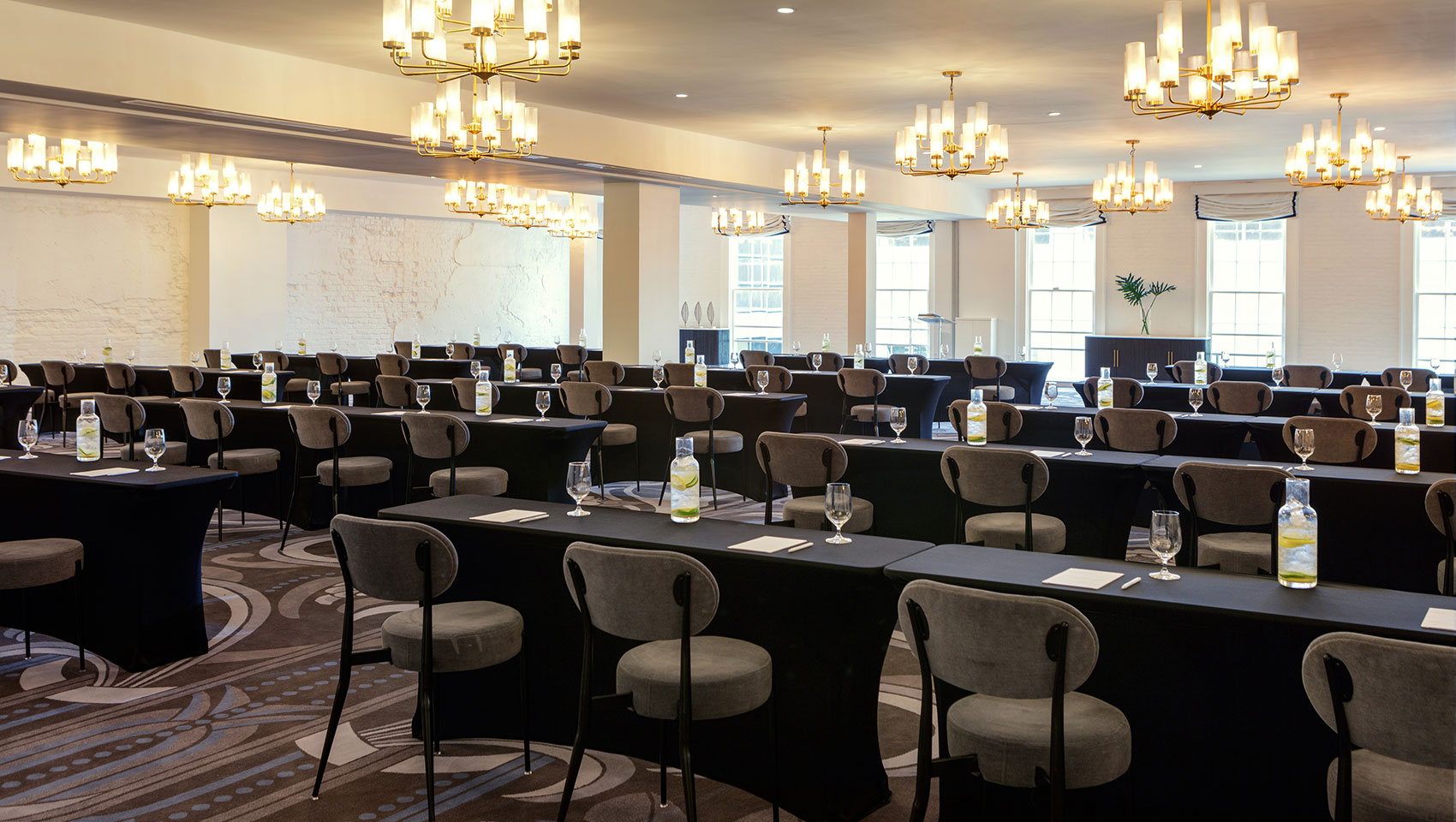 Hotel conference room set up with chairs and water bottles for a meeting