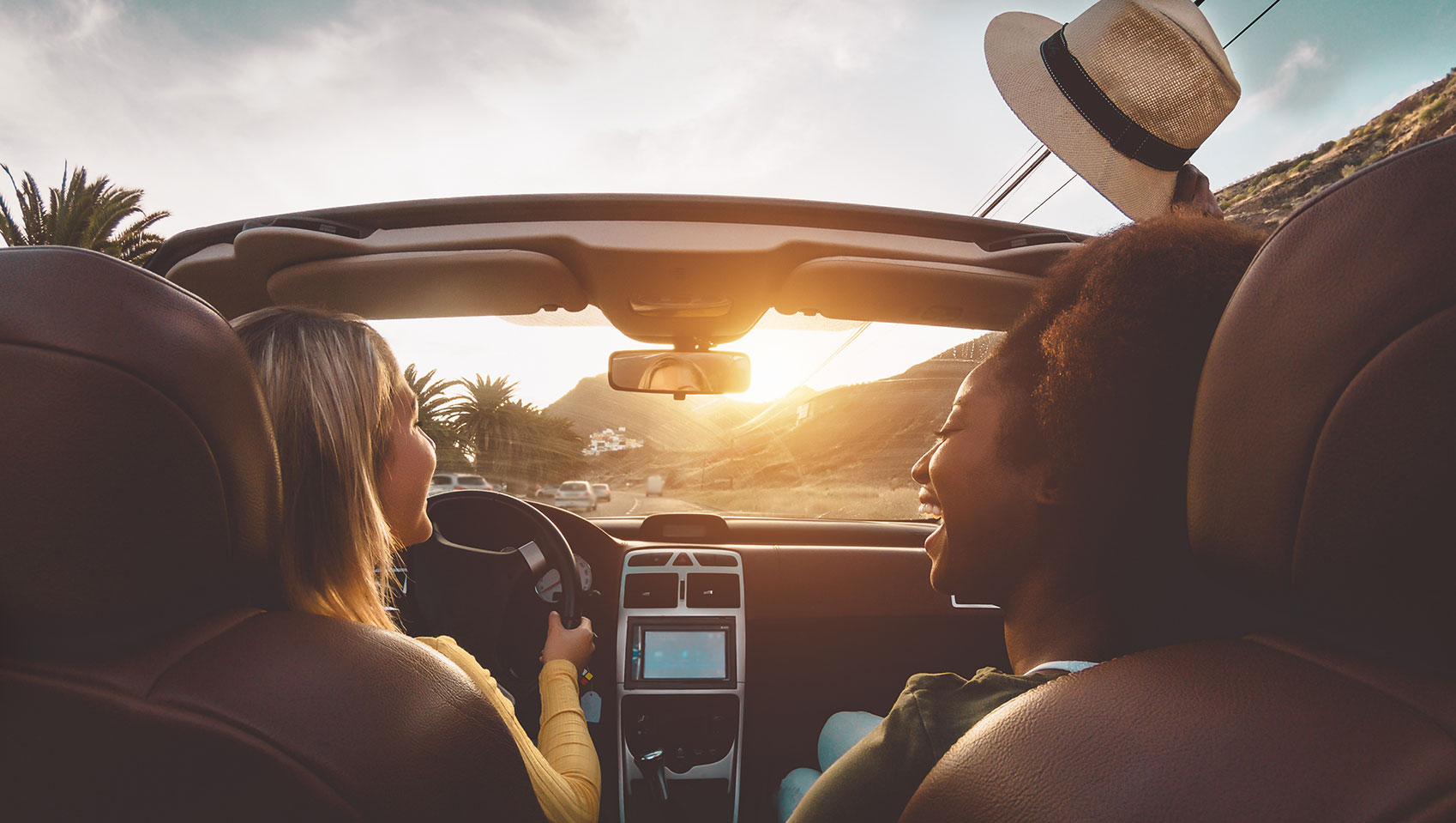 women driving in a convertible car