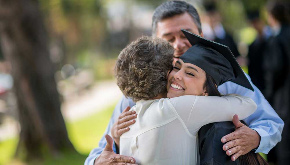 Grad hugging parents