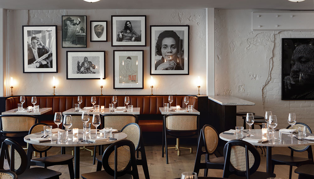 King Brasserie Interior with tables and photos on wall