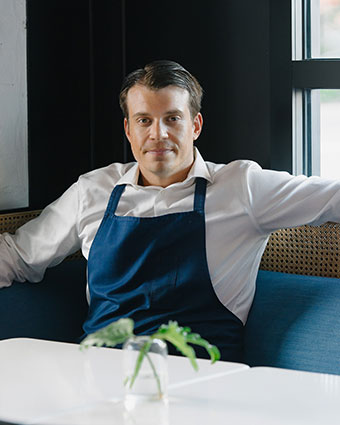 picture of Chef Samuel Peery sitting in a booth